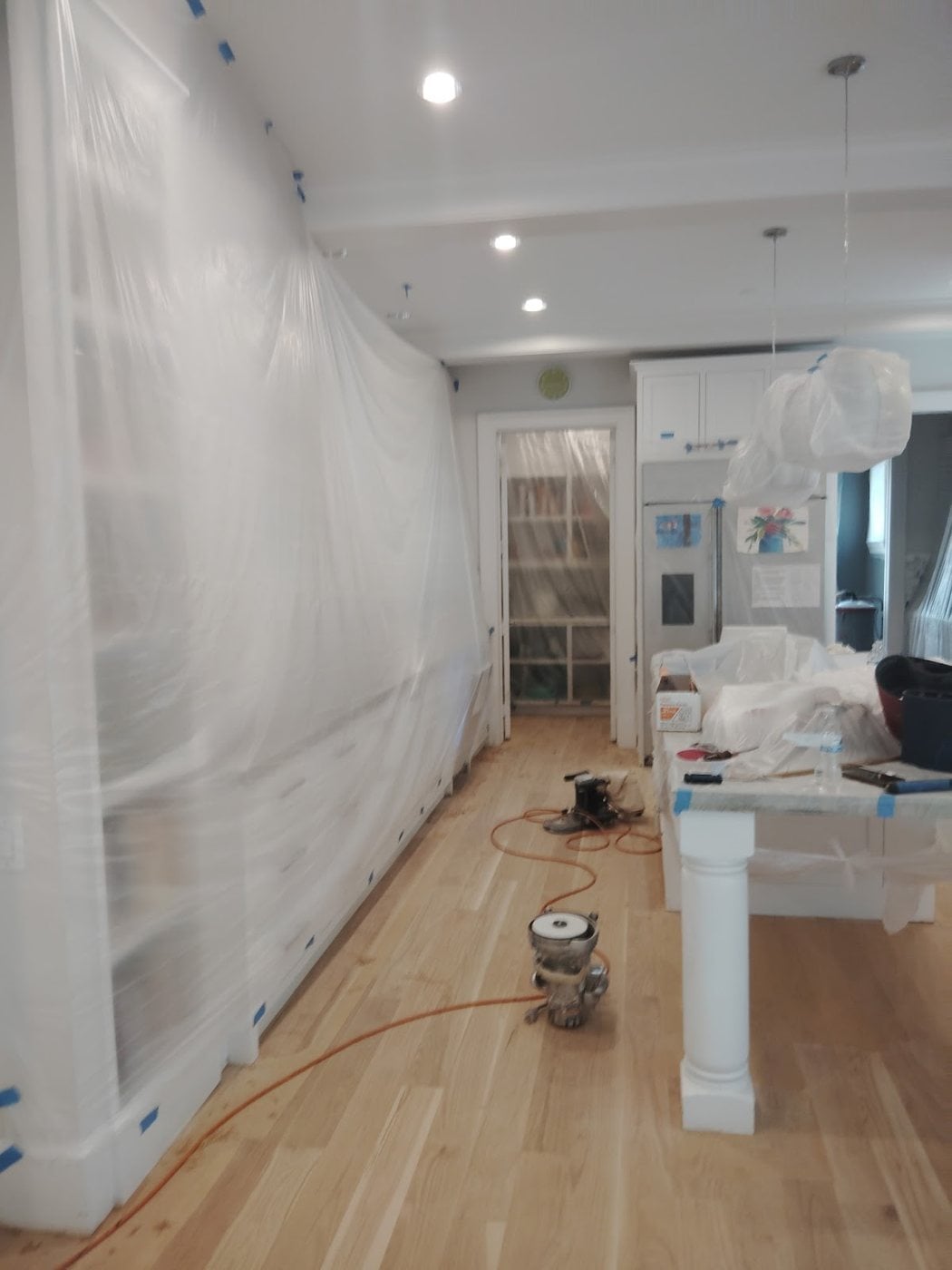 Bernard Hardwood Floors crew sanding a hardwood floor in a Dallas-Fort Worth home